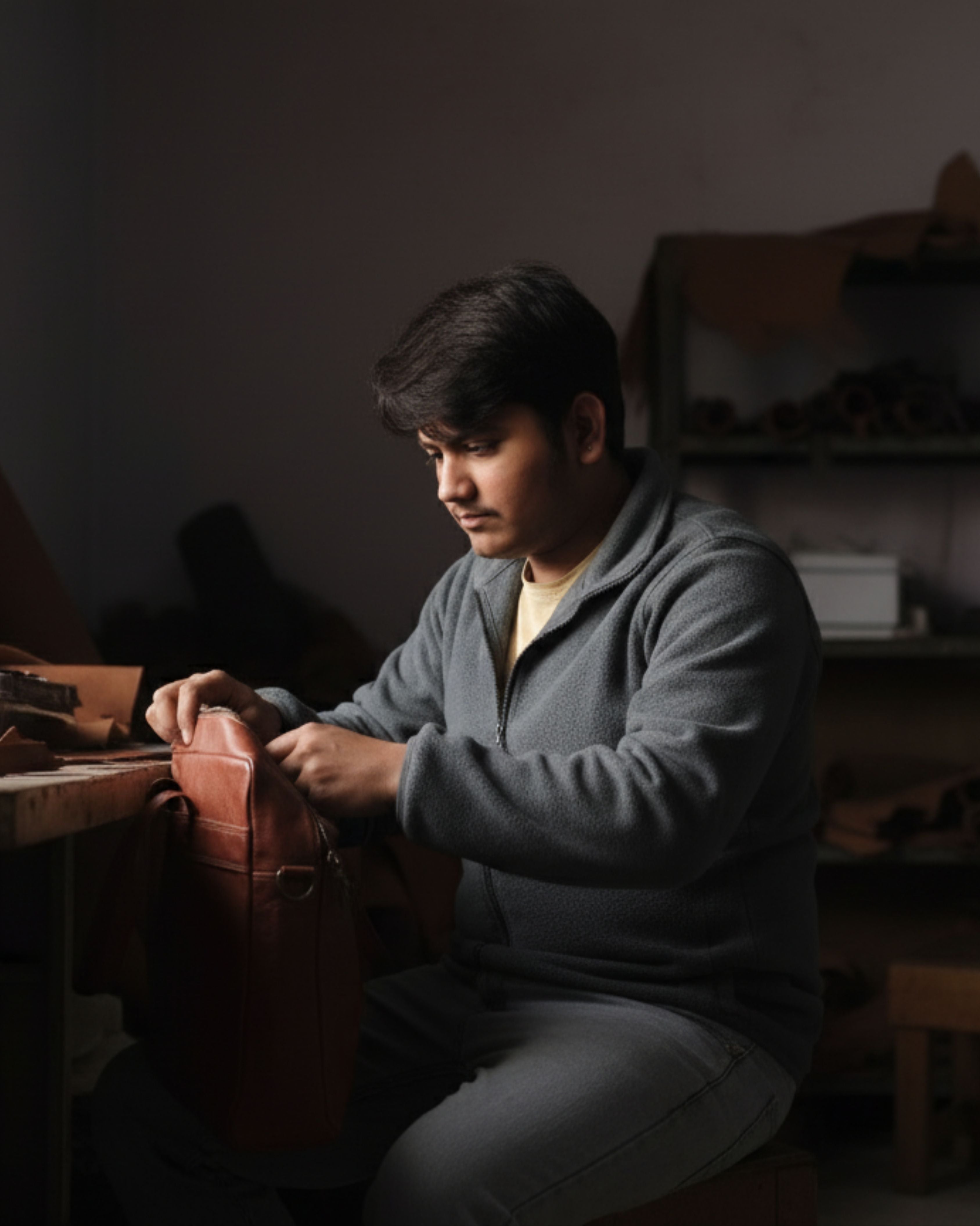 Manish Jeengar Artisan working with leather in a workshop setting