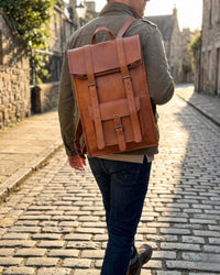 The Sariska Backpack, a tall 20-inch handcrafted tan goat leather fold-over rucksack with dual vertical straps by Jeengar.