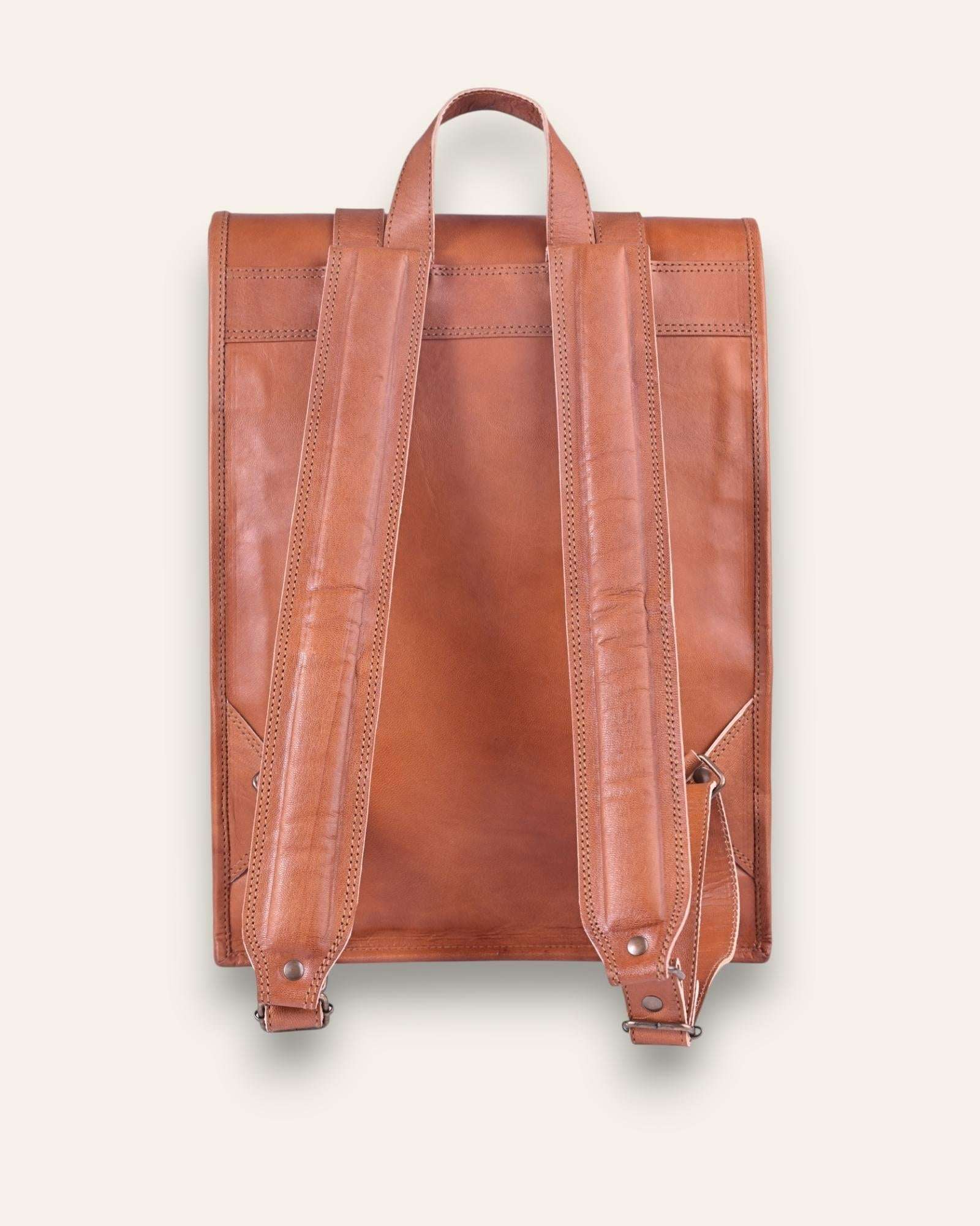 The Sariska Backpack, a tall 20-inch handcrafted tan goat leather fold-over rucksack with dual vertical straps by Jeengar.