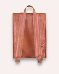 The Sariska Backpack, a tall 20-inch handcrafted tan goat leather fold-over rucksack with dual vertical straps by Jeengar.