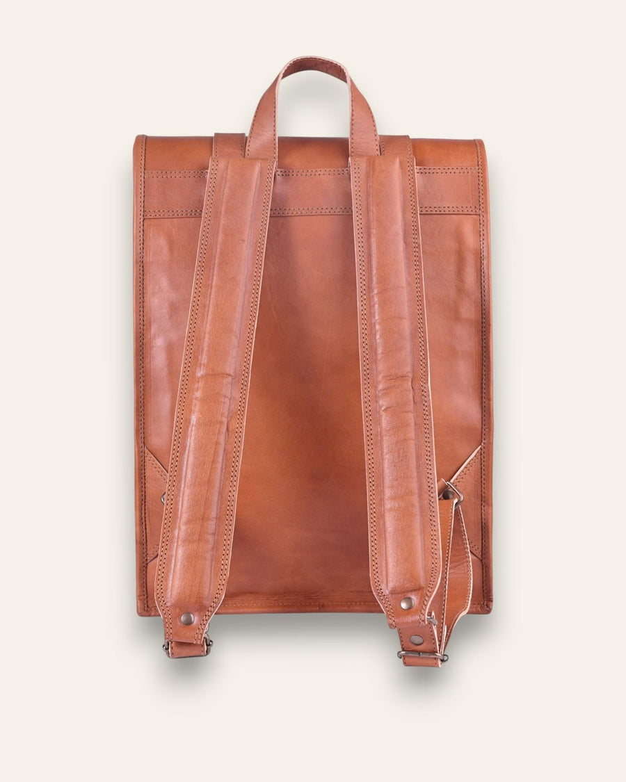The Sariska Backpack, a tall 20-inch handcrafted tan goat leather fold-over rucksack with dual vertical straps by Jeengar.