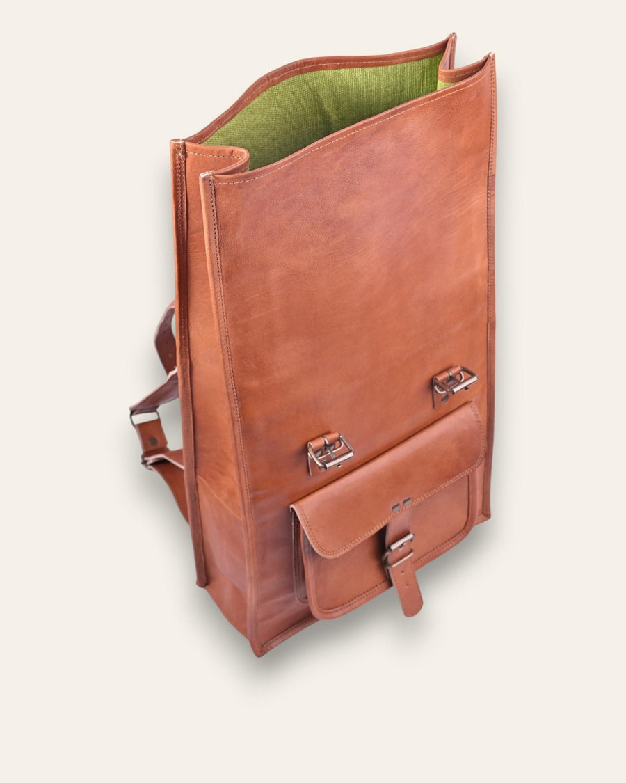 The Sariska Backpack, a tall 20-inch handcrafted tan goat leather fold-over rucksack with dual vertical straps by Jeengar.