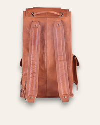 The Aravalli Backpack, a handcrafted tan goat leather rucksack featuring a buckled top flap and three exterior pockets by Jeengar.