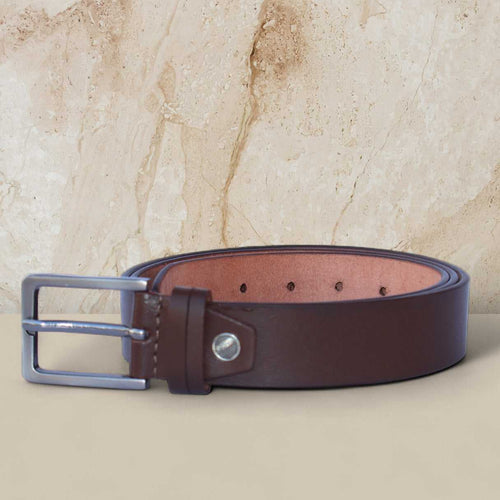Brown leather belt with silver buckle on a beige marble background