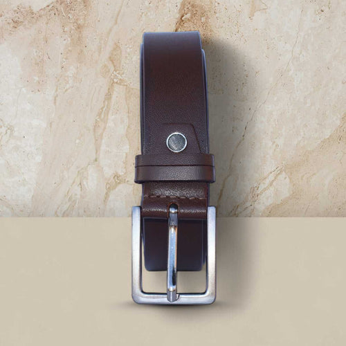 Brown leather belt with silver buckle on a beige marble background