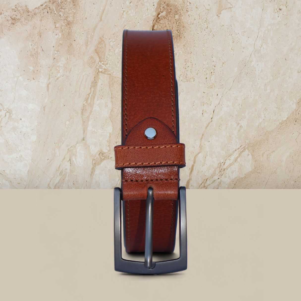 Brown leather belt with black buckle on a beige marble background