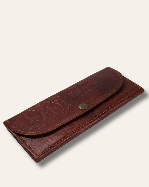 A real leather Ladies clutch or purse in cherry red color