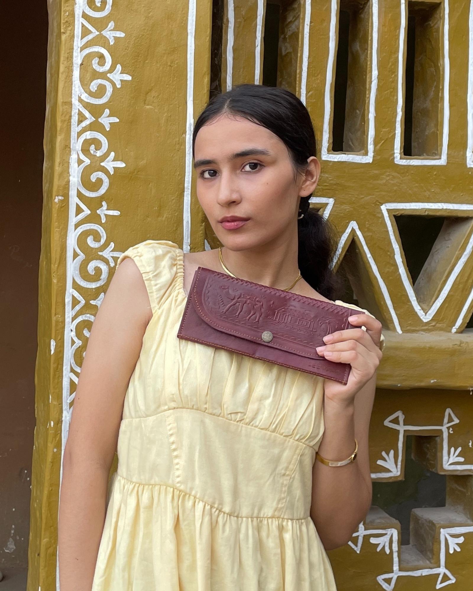 A real leather Ladies clutch or purse in cherry red color