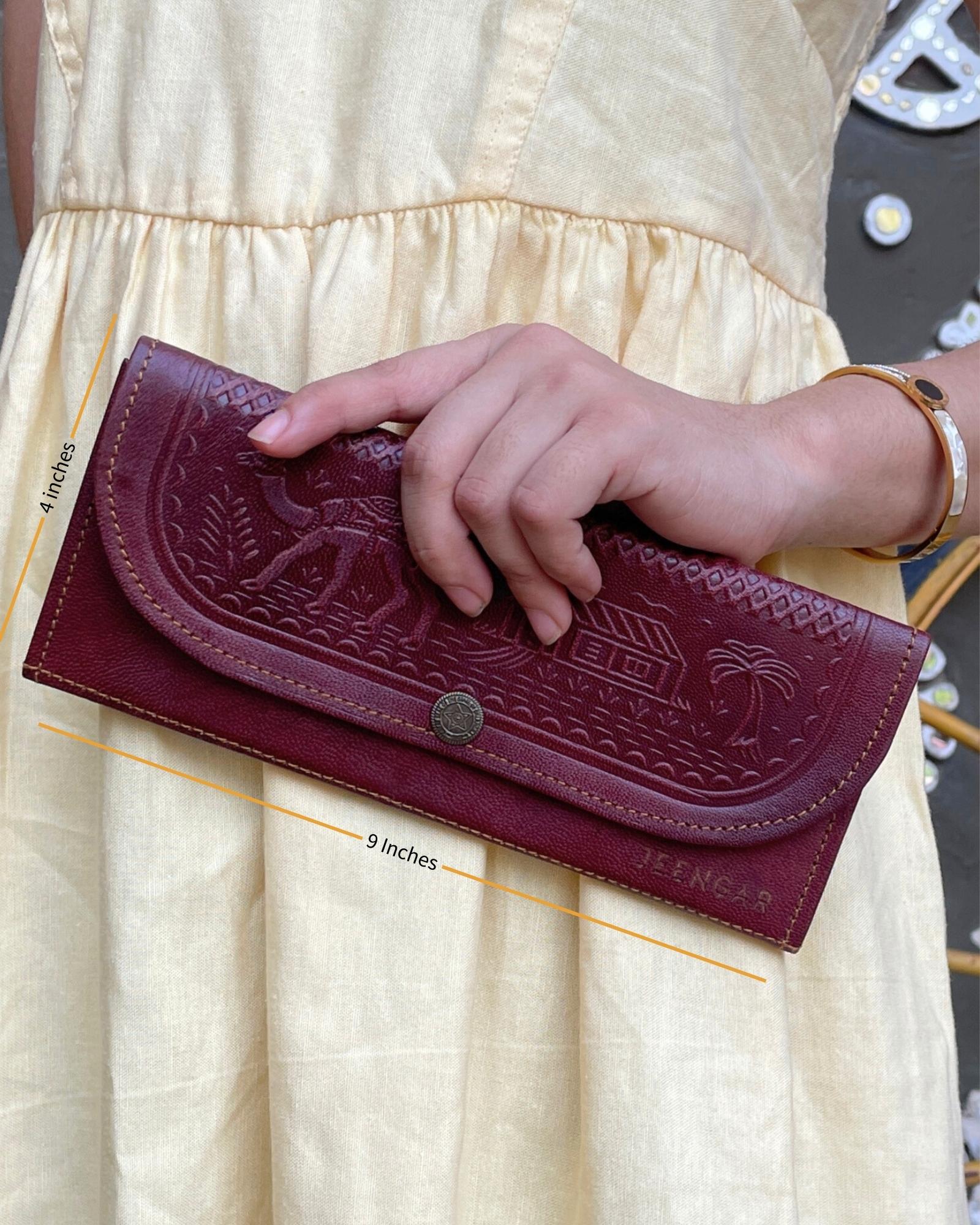 A real leather Ladies clutch or purse in cherry red color
