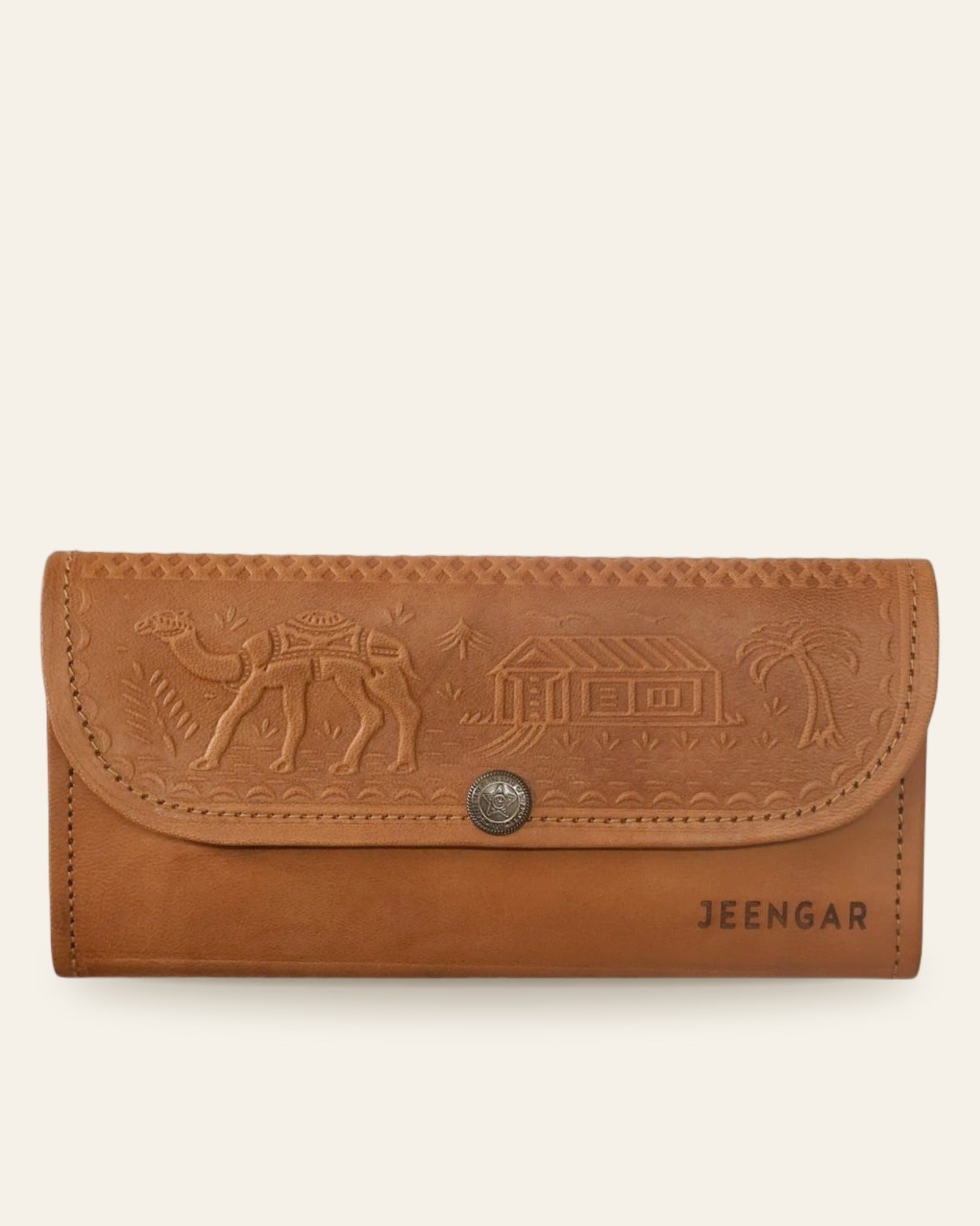 The Gangaur Clutch in Tan — front view with embossed desert scene and antique concho