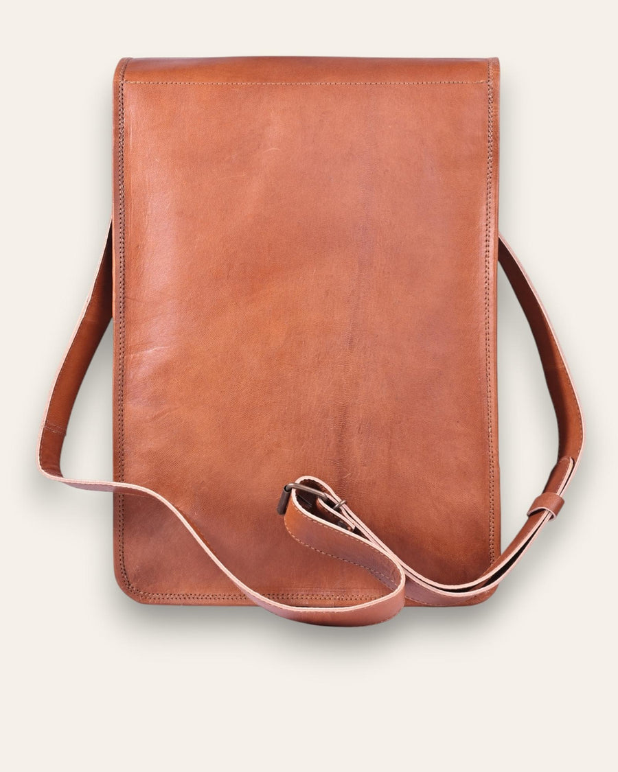 The Bundi Crossbody Bag, a tall handcrafted tan goat leather bag featuring a diagonal zipper