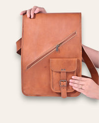 The Bundi Crossbody Bag, a tall handcrafted tan goat leather bag featuring a diagonal zipper