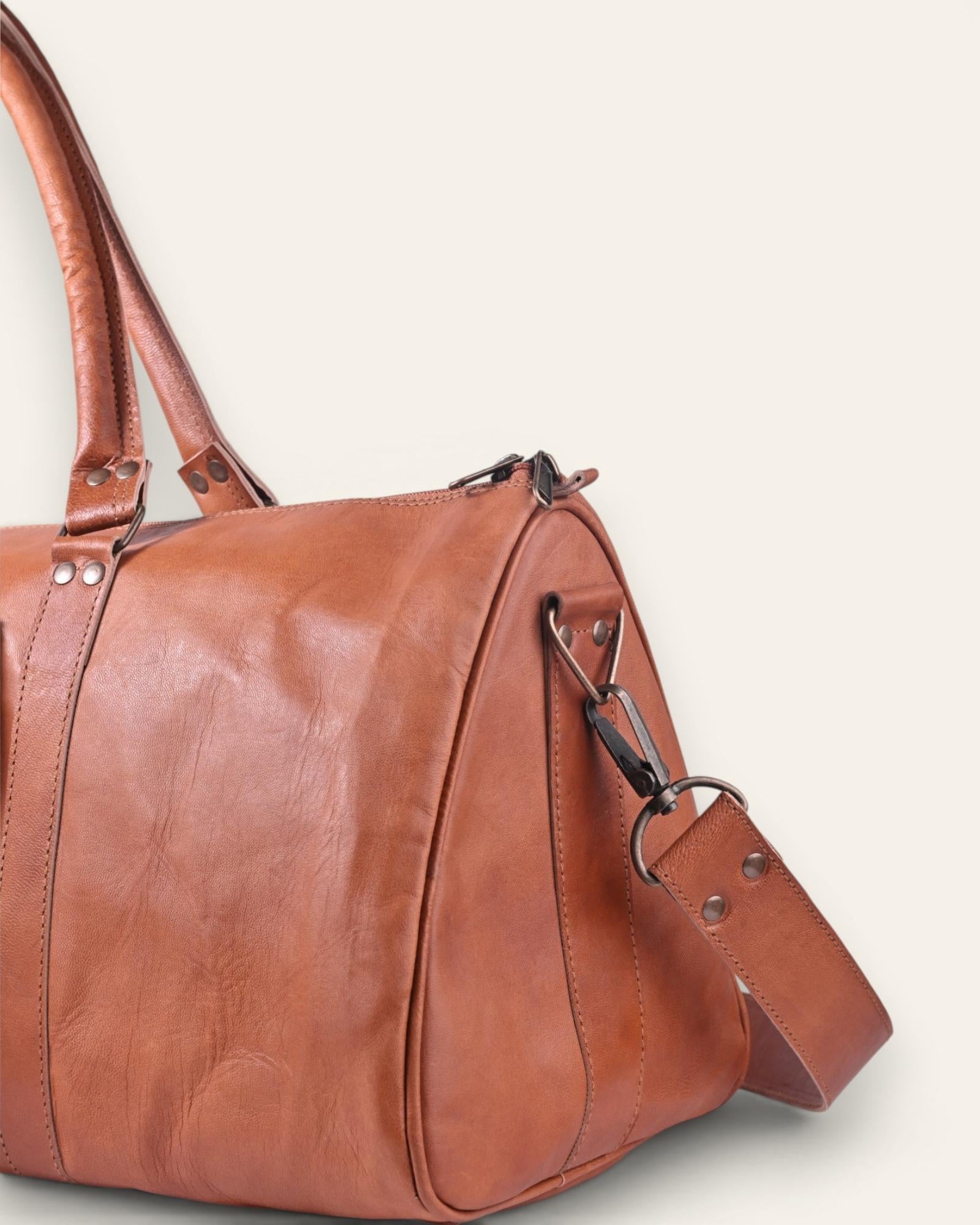 A triangle shapped duffel bag in real tan leather color
