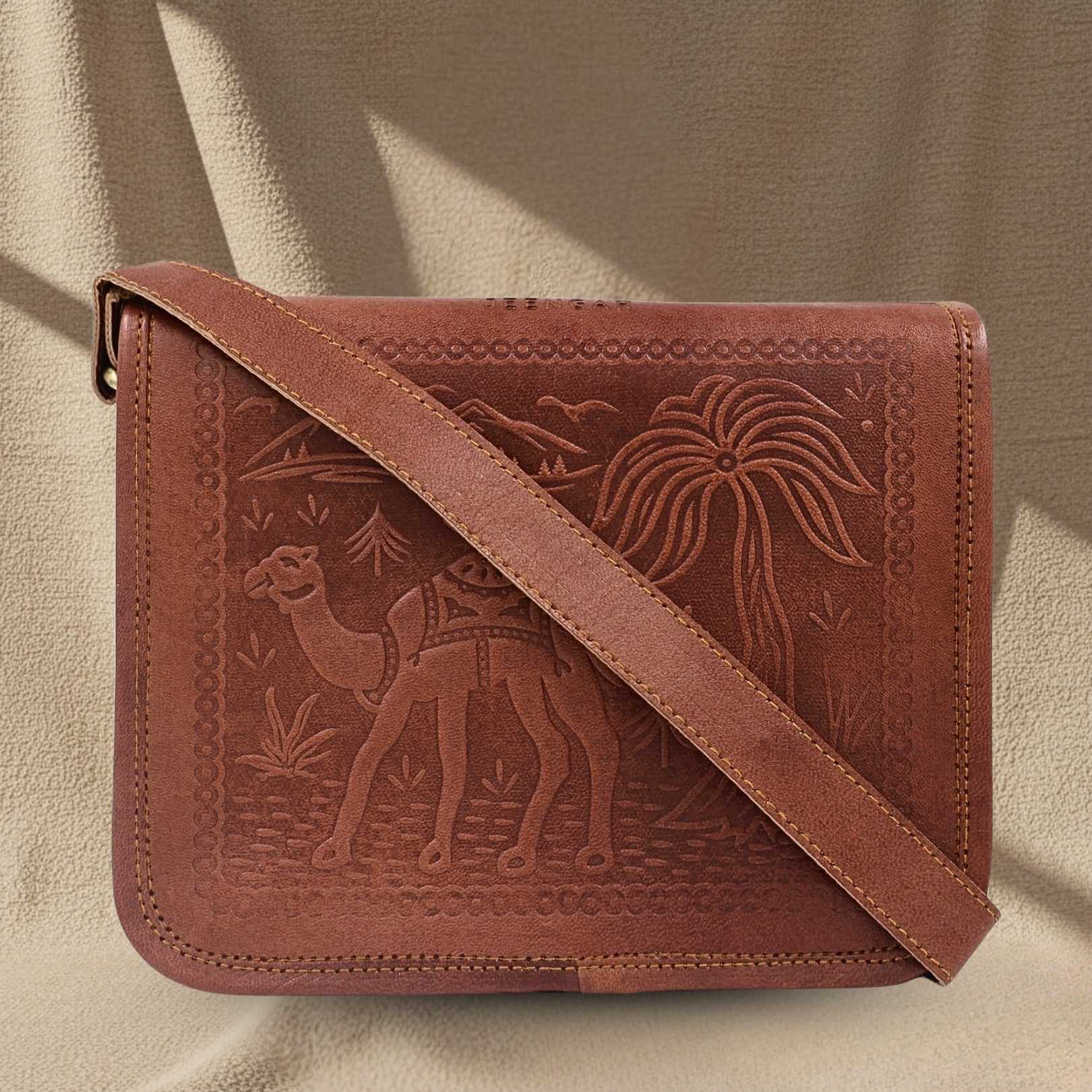 Brown leather bag with embossed designs of a camel and palm tree on a beige background