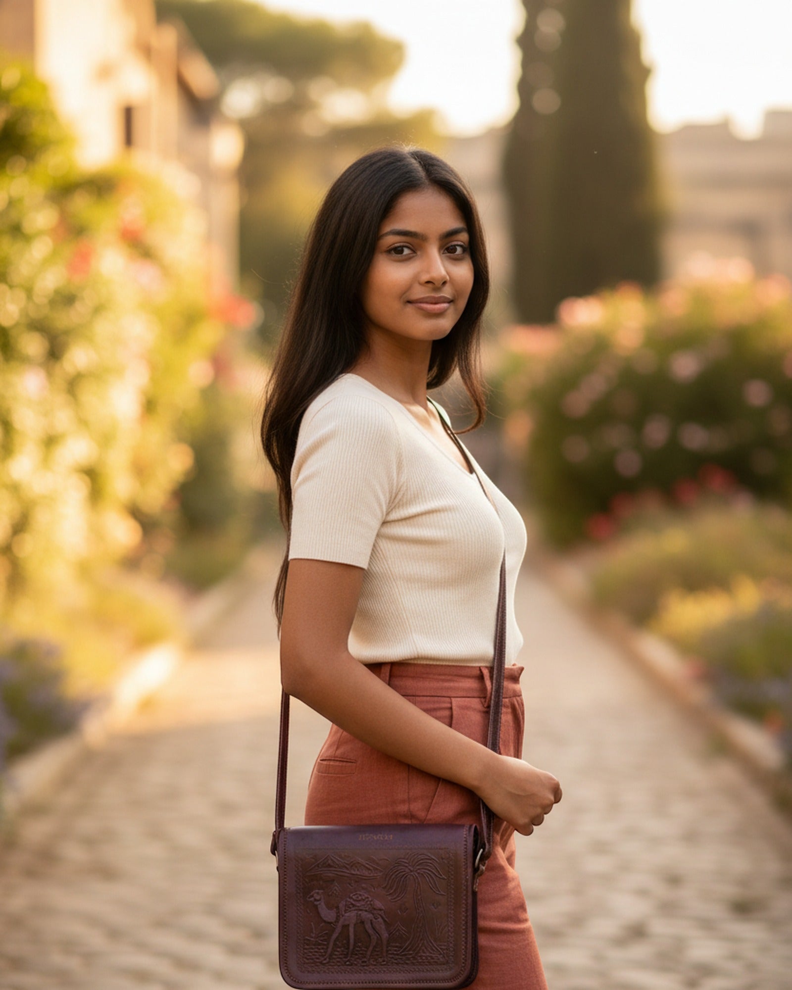 The Jaisalmer Sling in Cherry worn cross-body at golden hour