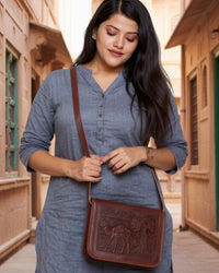 a cherry color real leather sling bag. Handmade in rajasthan
