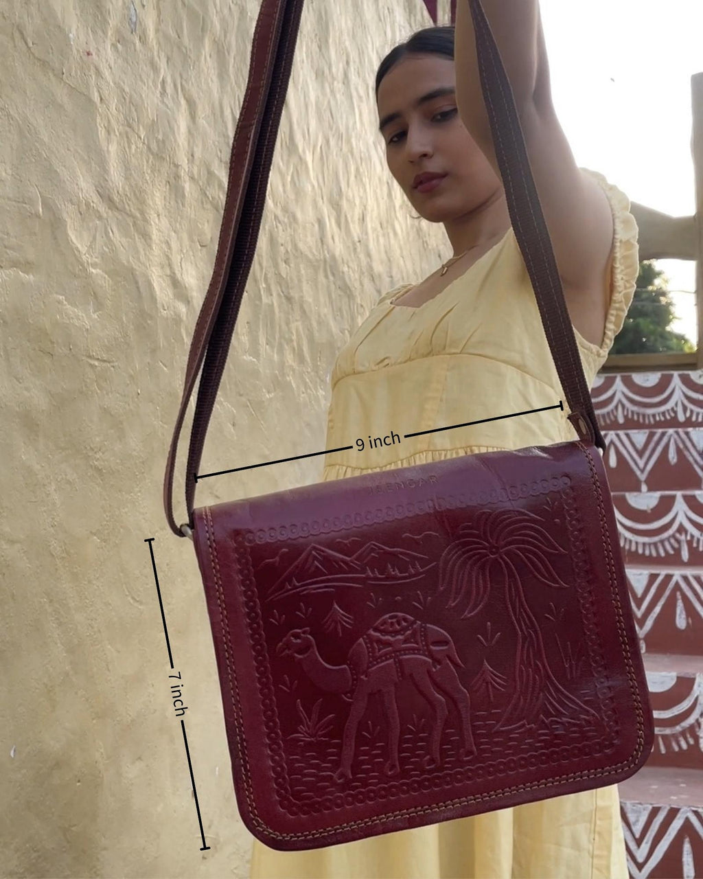 a cherry color real leather sling bag. Handmade in rajasthan