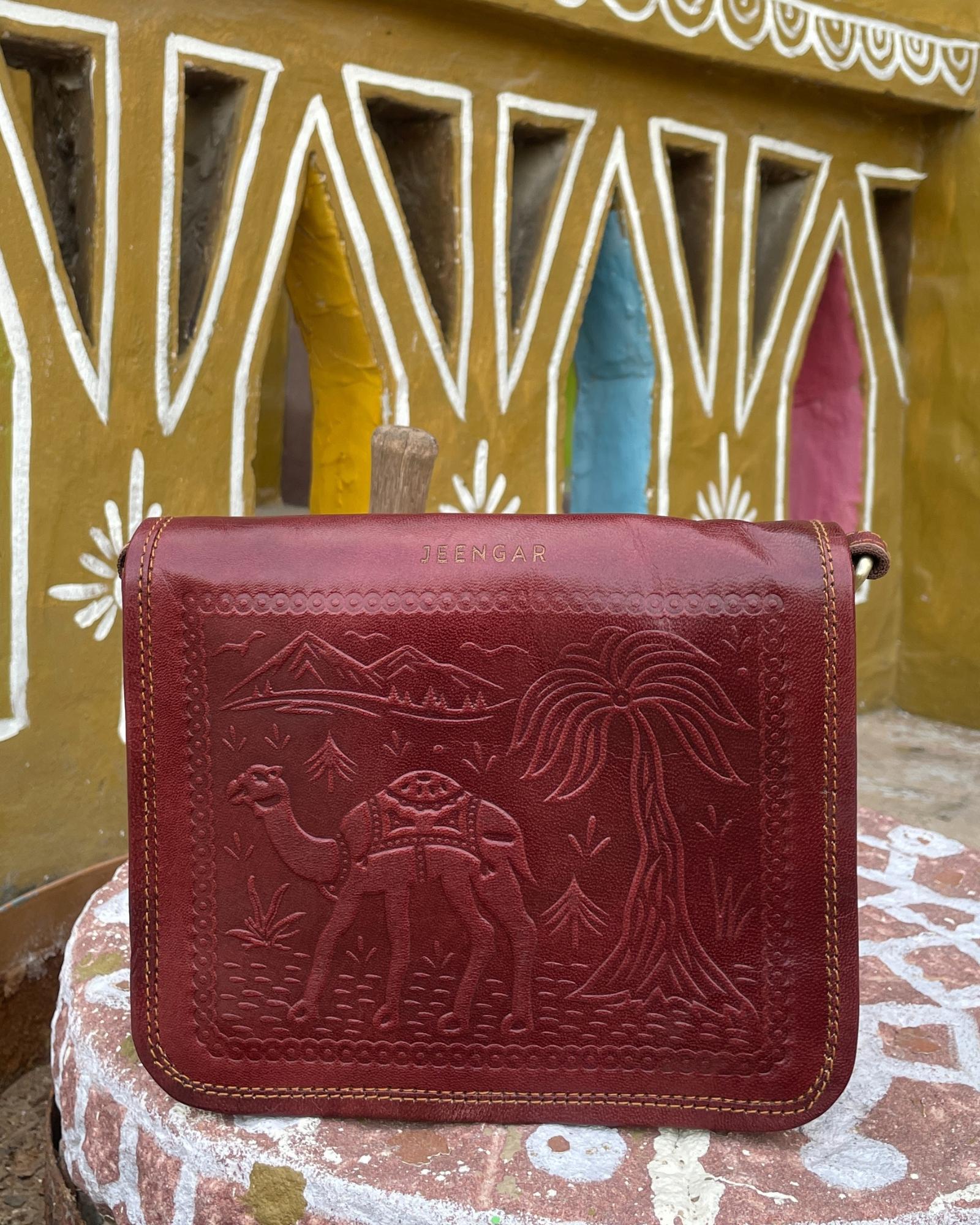 a cherry color real leather sling bag. Handmade in rajasthan