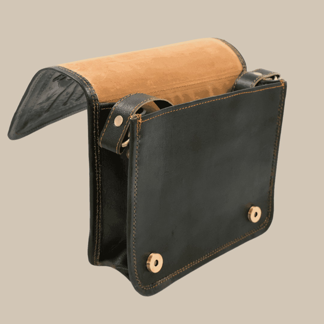 A dark olive green leather bag with a tan interior on a beige background