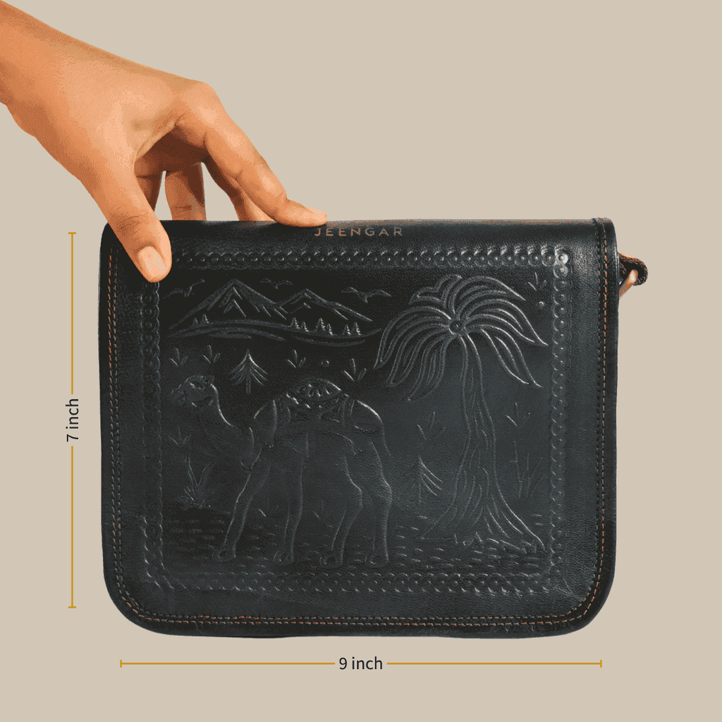 A dark olive green embossed handbag held by a hand with dimensions indicated, on a beige background.