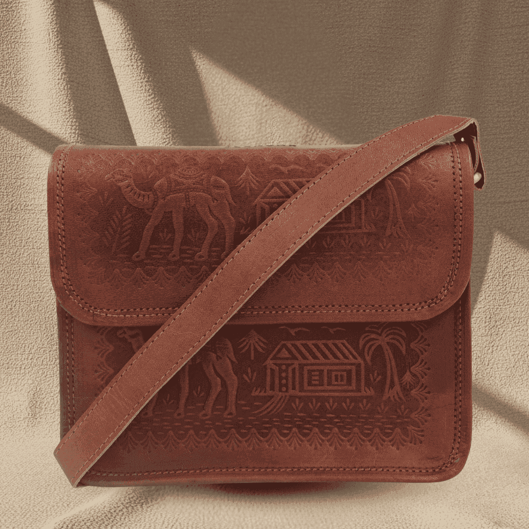 Brown leather bag with embossed designs on a beige background