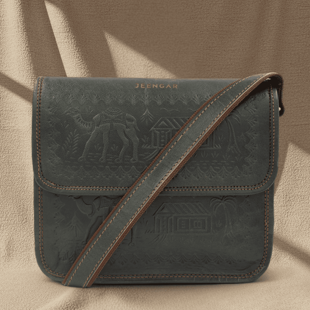 Dark Olive leather handbag with embossed designs and brown strap on a beige background