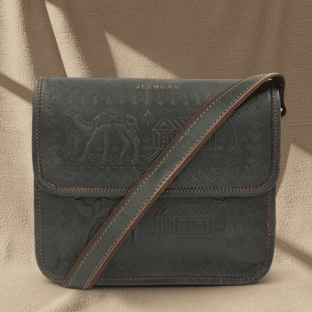 Dark Olive leather handbag with embossed designs and brown strap on a beige background
