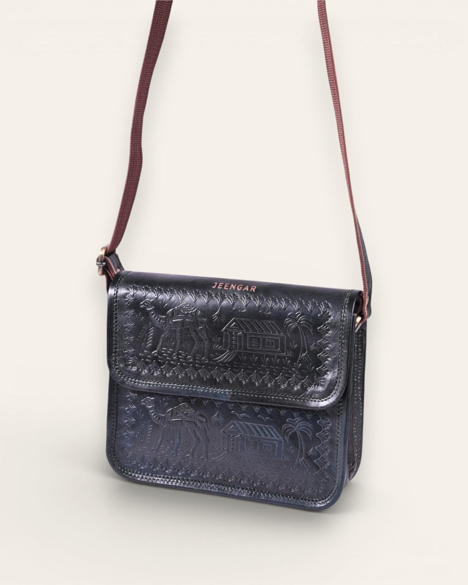 A dark green real leather sling bag handmade by jeengar artisans