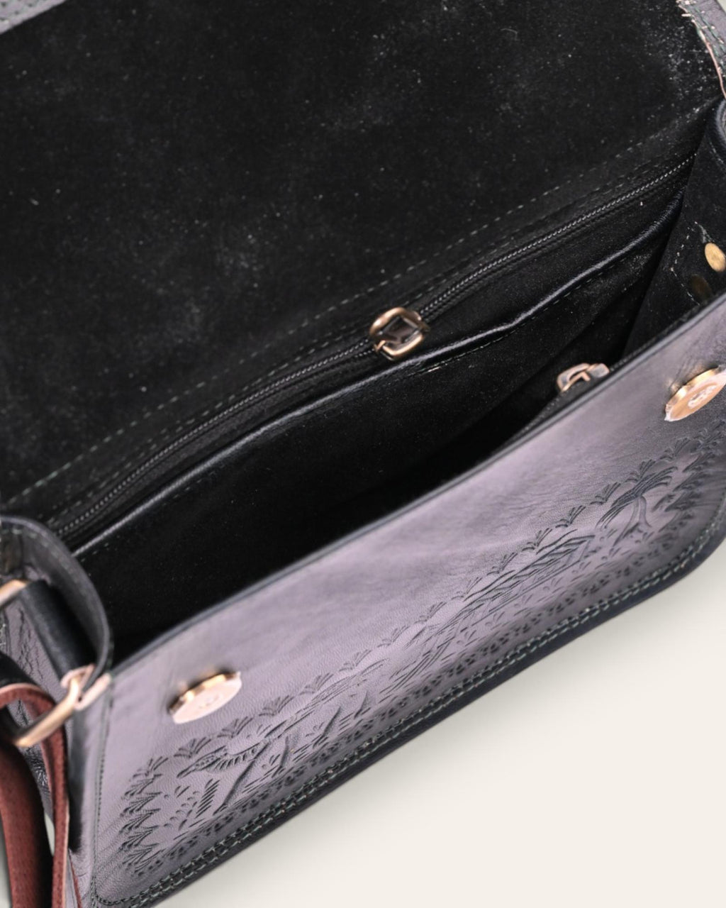 A dark green real leather sling bag handmade by jeengar artisans