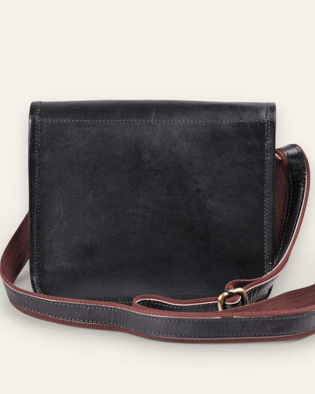 A dark green real leather sling bag handmade by jeengar artisans