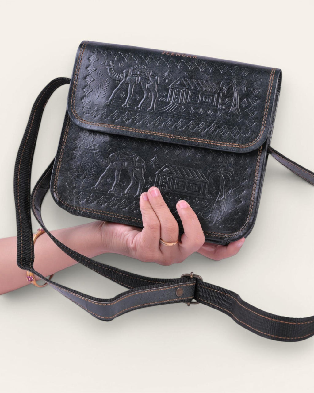 A dark green real leather sling bag handmade by jeengar artisans