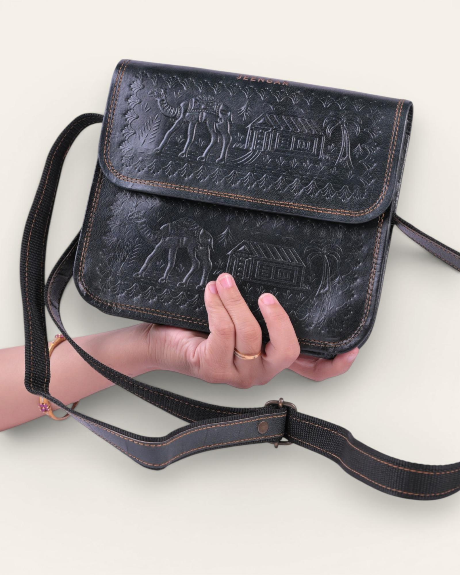 A dark green real leather sling bag handmade by jeengar artisans
