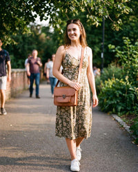 A real leather sling bag in tan color