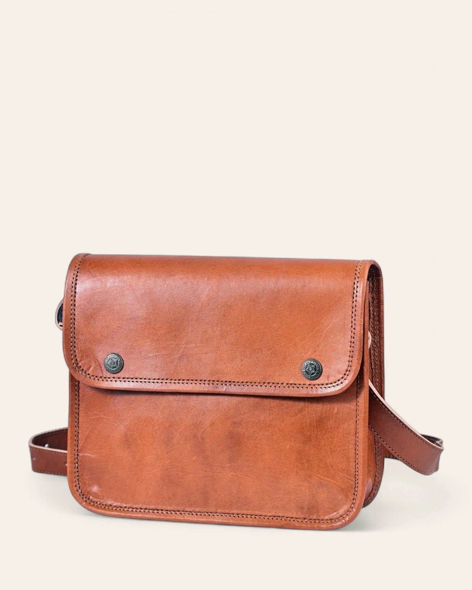 The Pushkar Sling, Button style in natural certified leather, front view with single artisan button closure