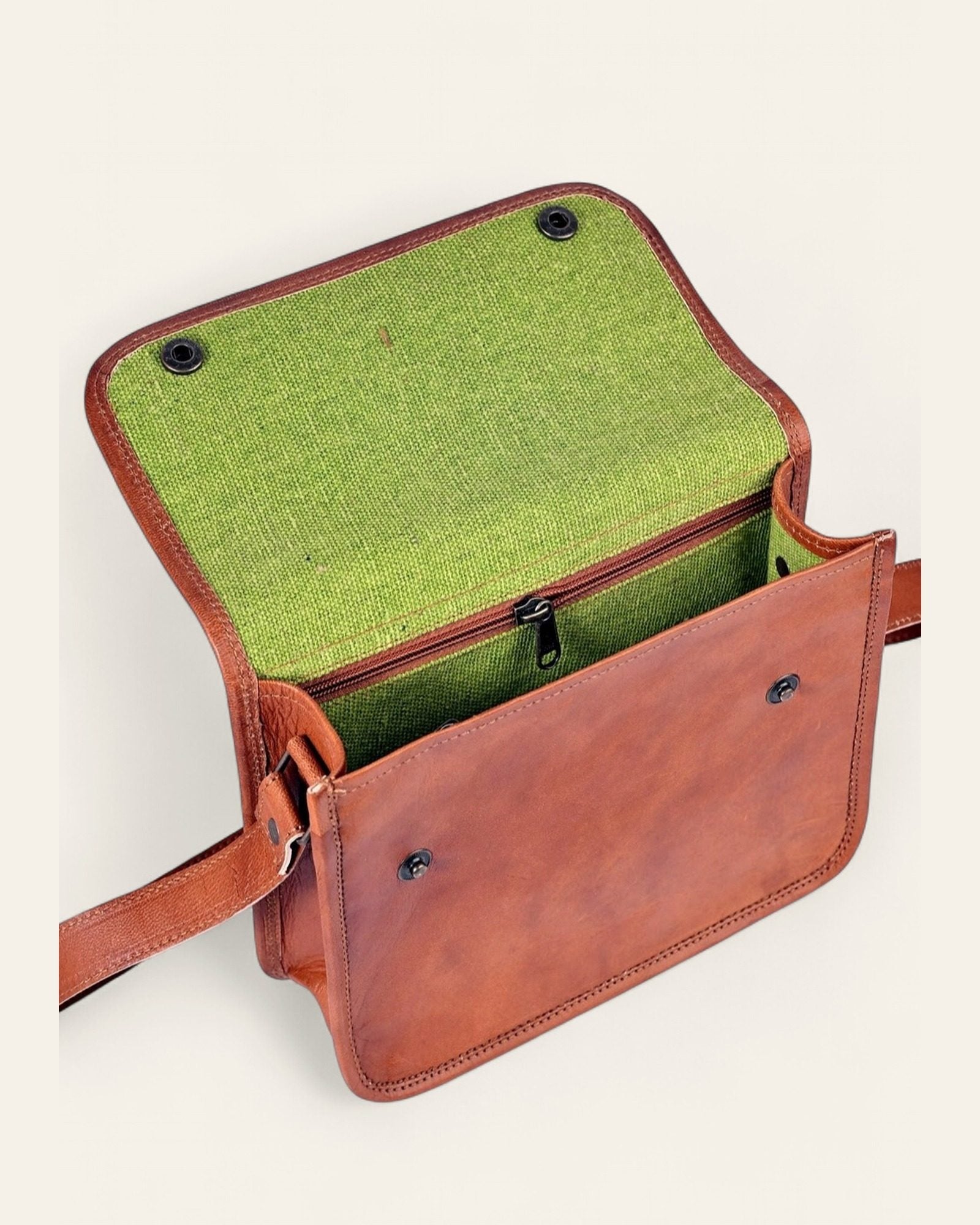 The Deogarh Sling open, revealing its bright-green canvas interior