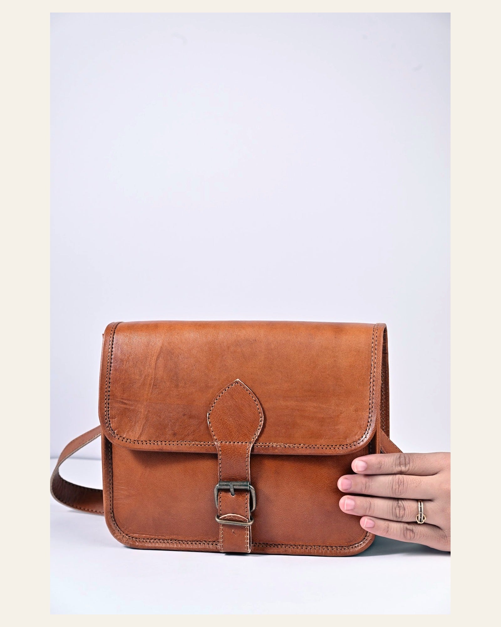 The Deogarh Sling Buckle Strap style held in hand