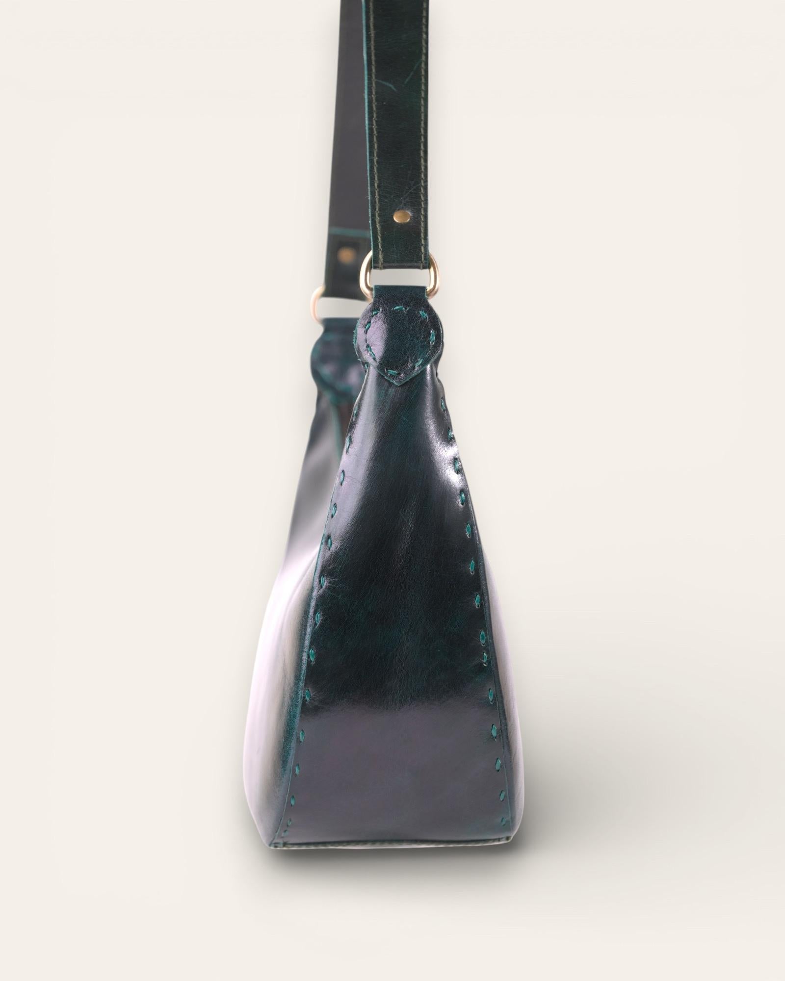 A dark green color real leather shoulder bag. It's spacious and beautiful.