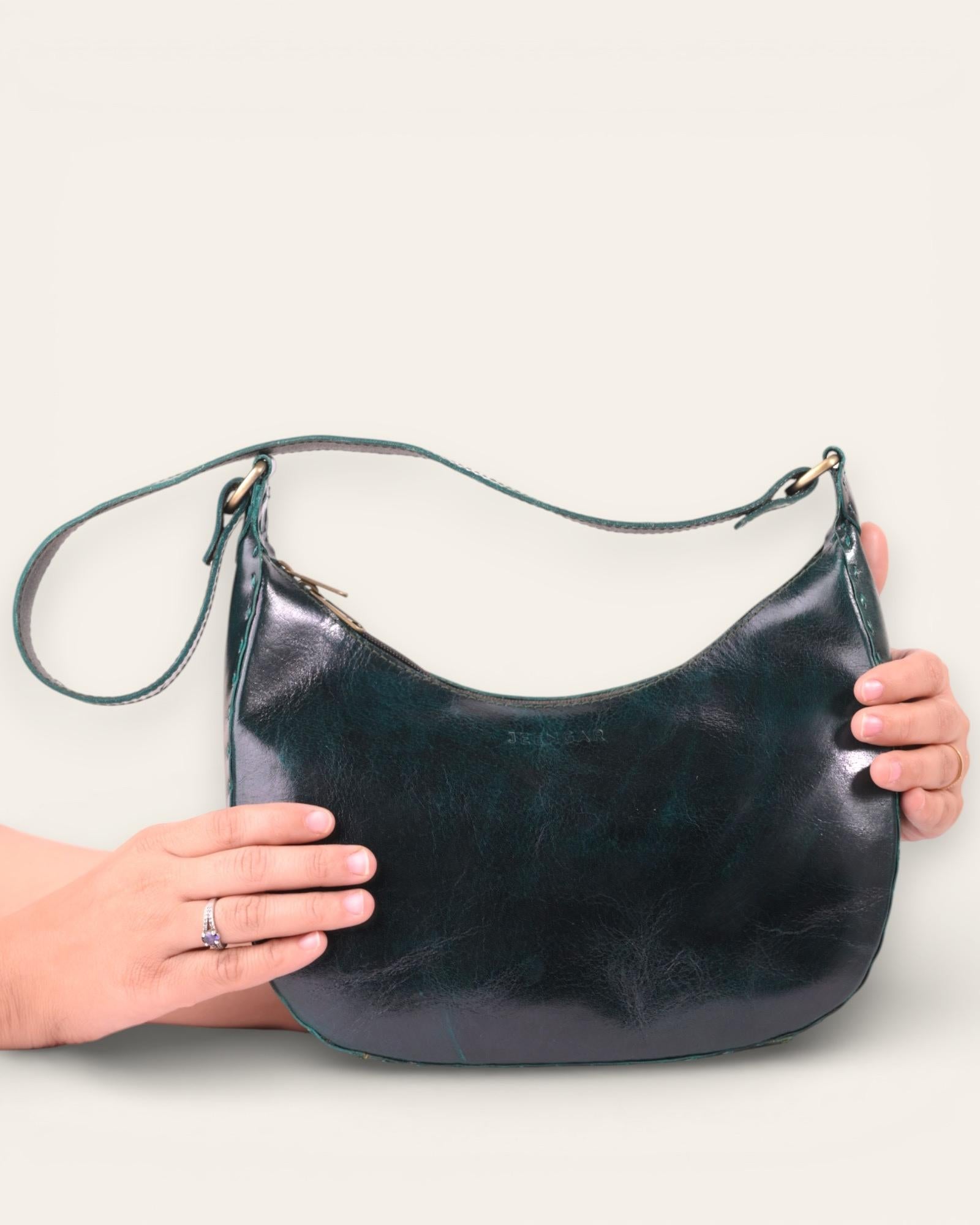 A dark green color real leather shoulder bag. It's spacious and beautiful.