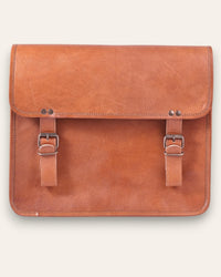 The Umaid Briefcase, a 15-inch handcrafted tan goat leather laptop bag with a no top handle and dual brass clasps by Jeengar.