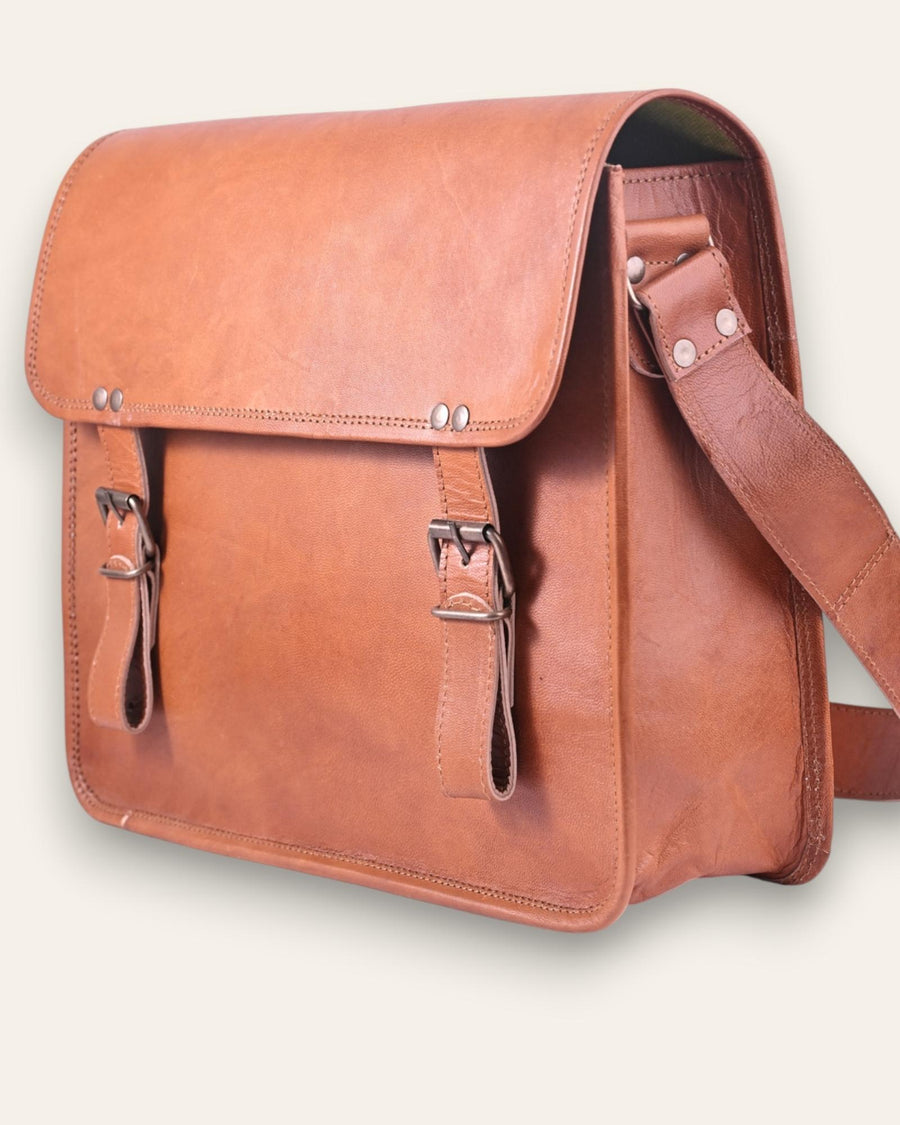 The Umaid Briefcase, a 15-inch handcrafted tan goat leather laptop bag with a no top handle and dual brass clasps by Jeengar.