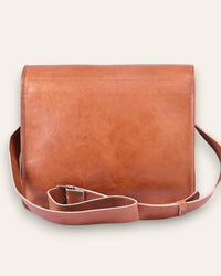 The Umaid Briefcase, a 15-inch handcrafted tan goat leather laptop bag with a no top handle and dual brass clasps by Jeengar.