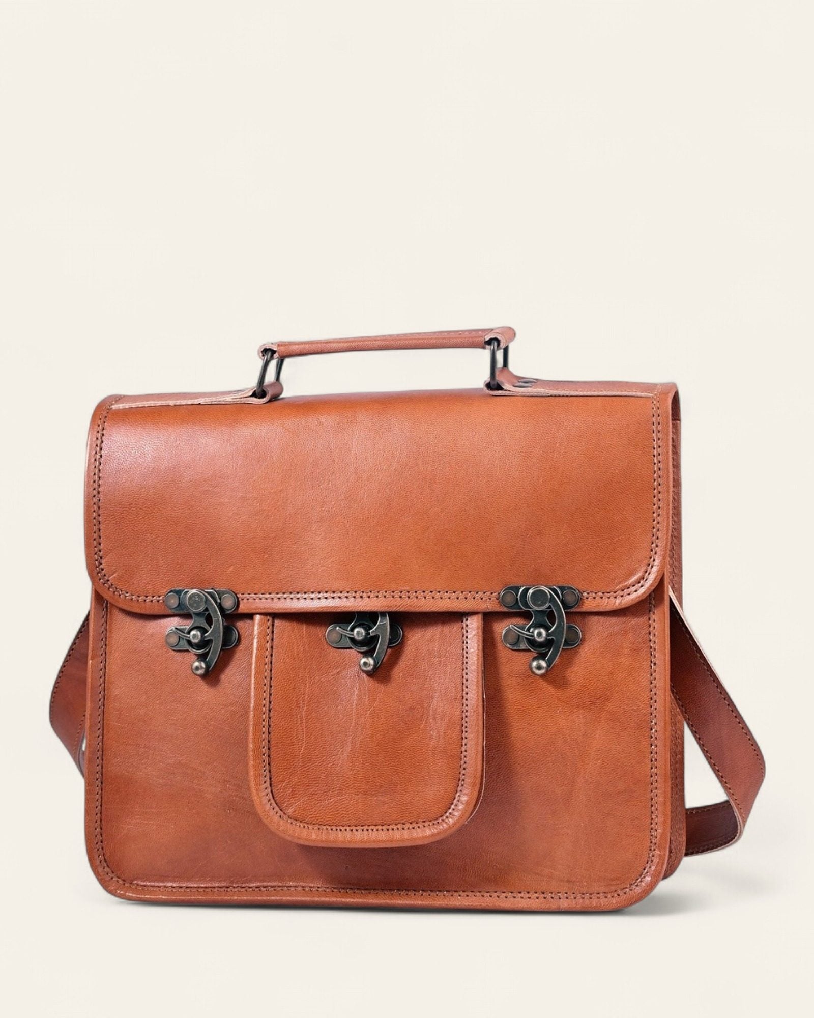 The Neemrana Twist-Lock Messenger, three-quarter view of the leather and twist-lock clasp