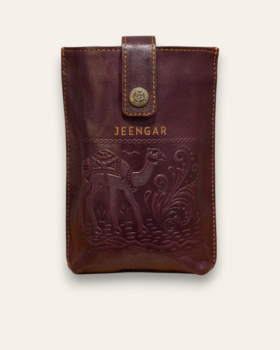 The Osian Mobile Sling, a handcrafted cherry red leather phone bag featuring a hand-embossed camel motif by Jeengar.