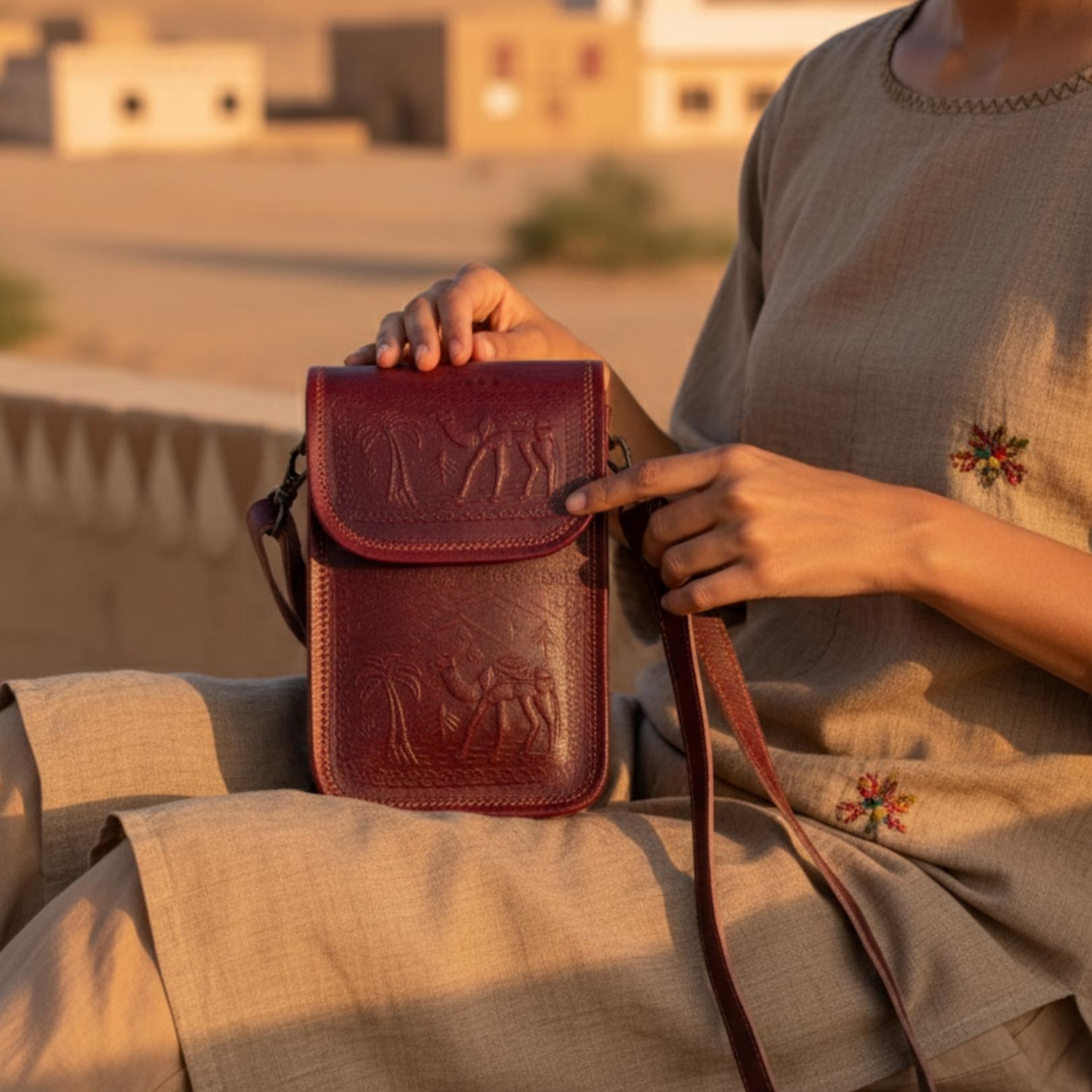 Cherry color handmade mobile leather sling bag. 