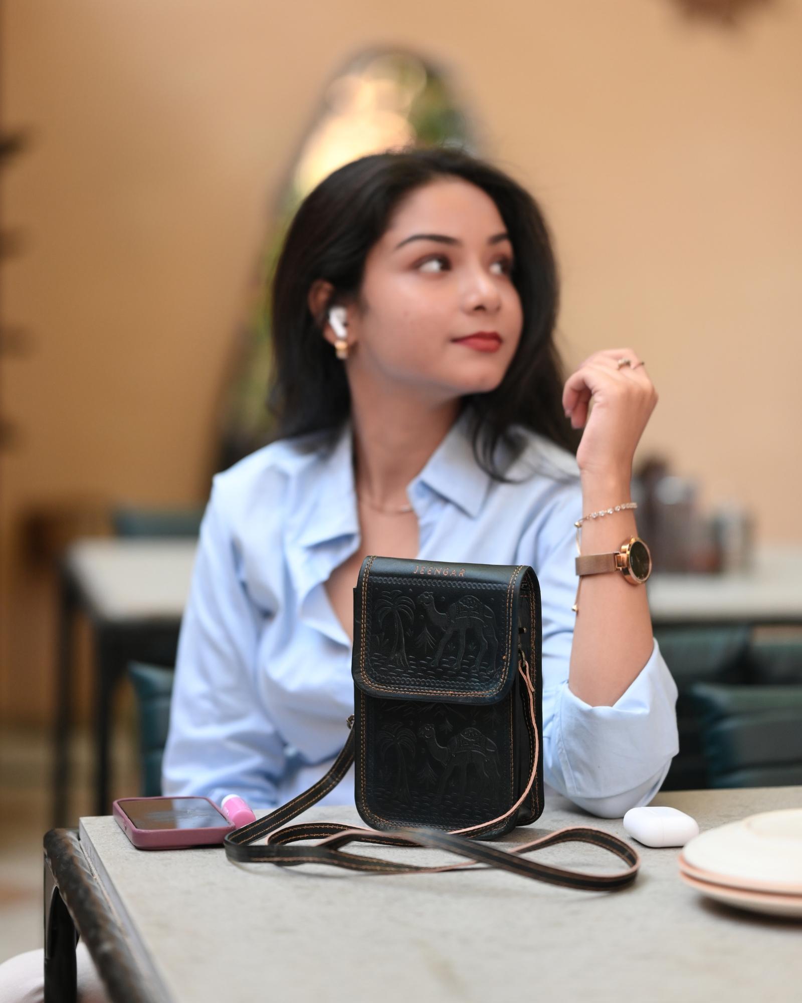 A compact mobile sling bag made with real leather, ideal for daily use