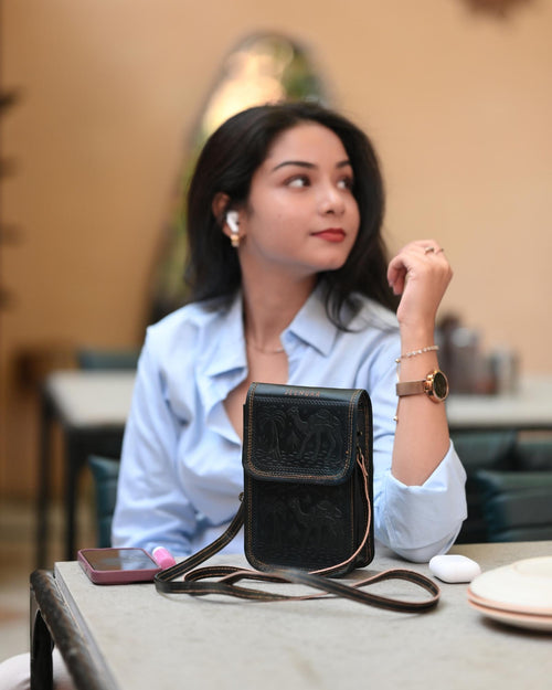 A compact mobile sling bag made with real leather, ideal for daily use