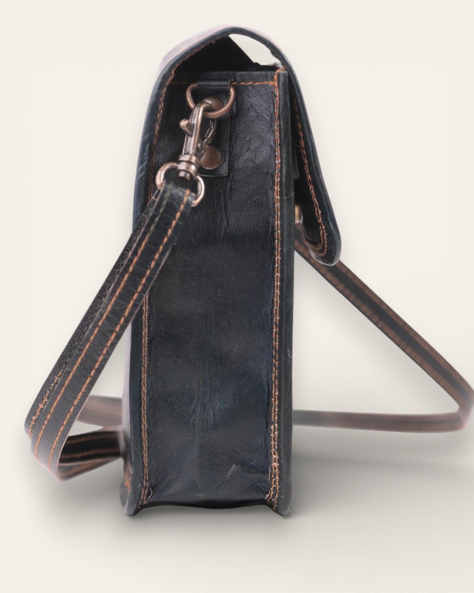 A compact mobile sling bag made with real leather, ideal for daily use