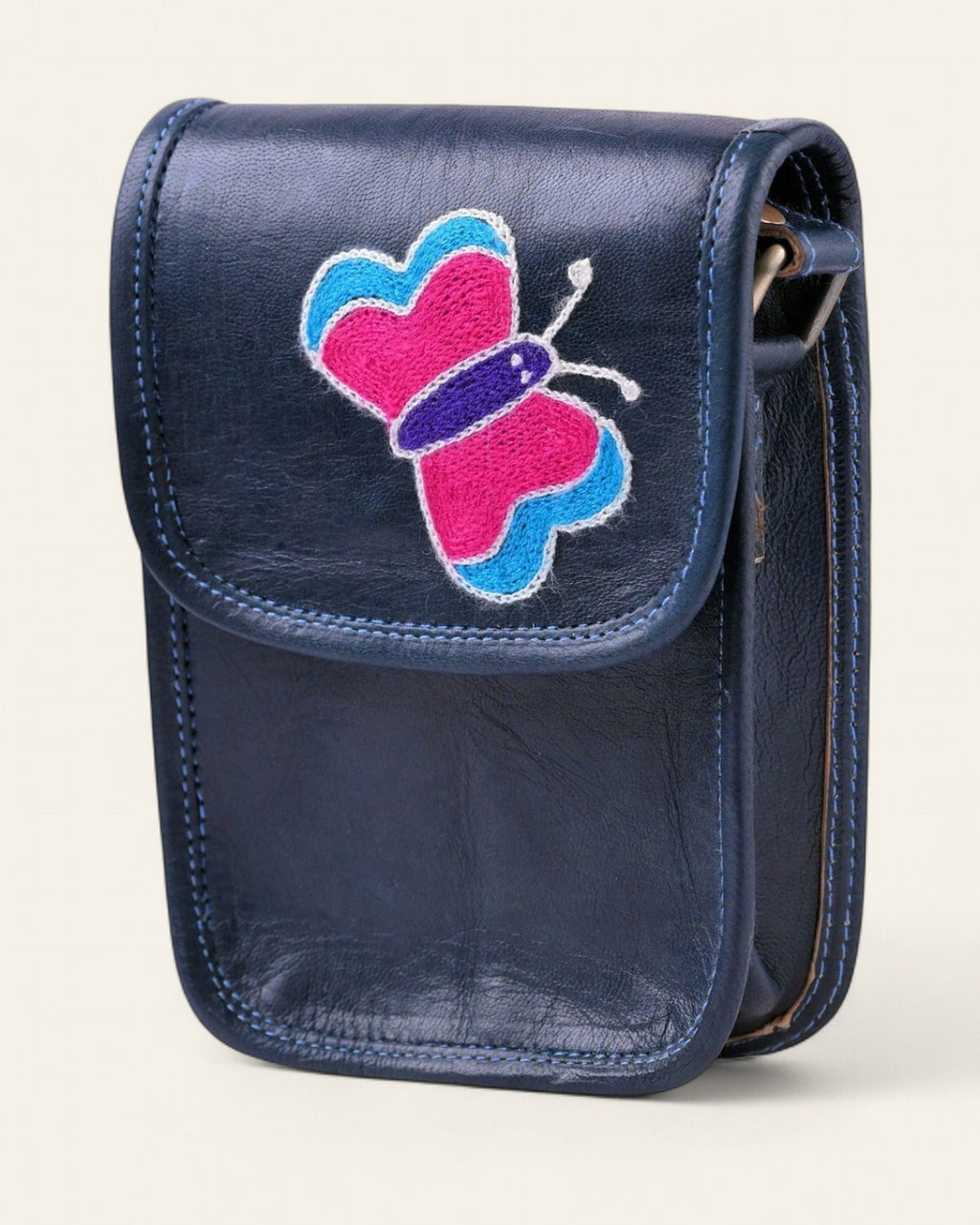 The Nagaur Kashidakari Sling — navy certified real leather mobile sling with a hand-embroidered Kashidakari butterfly motif, front view