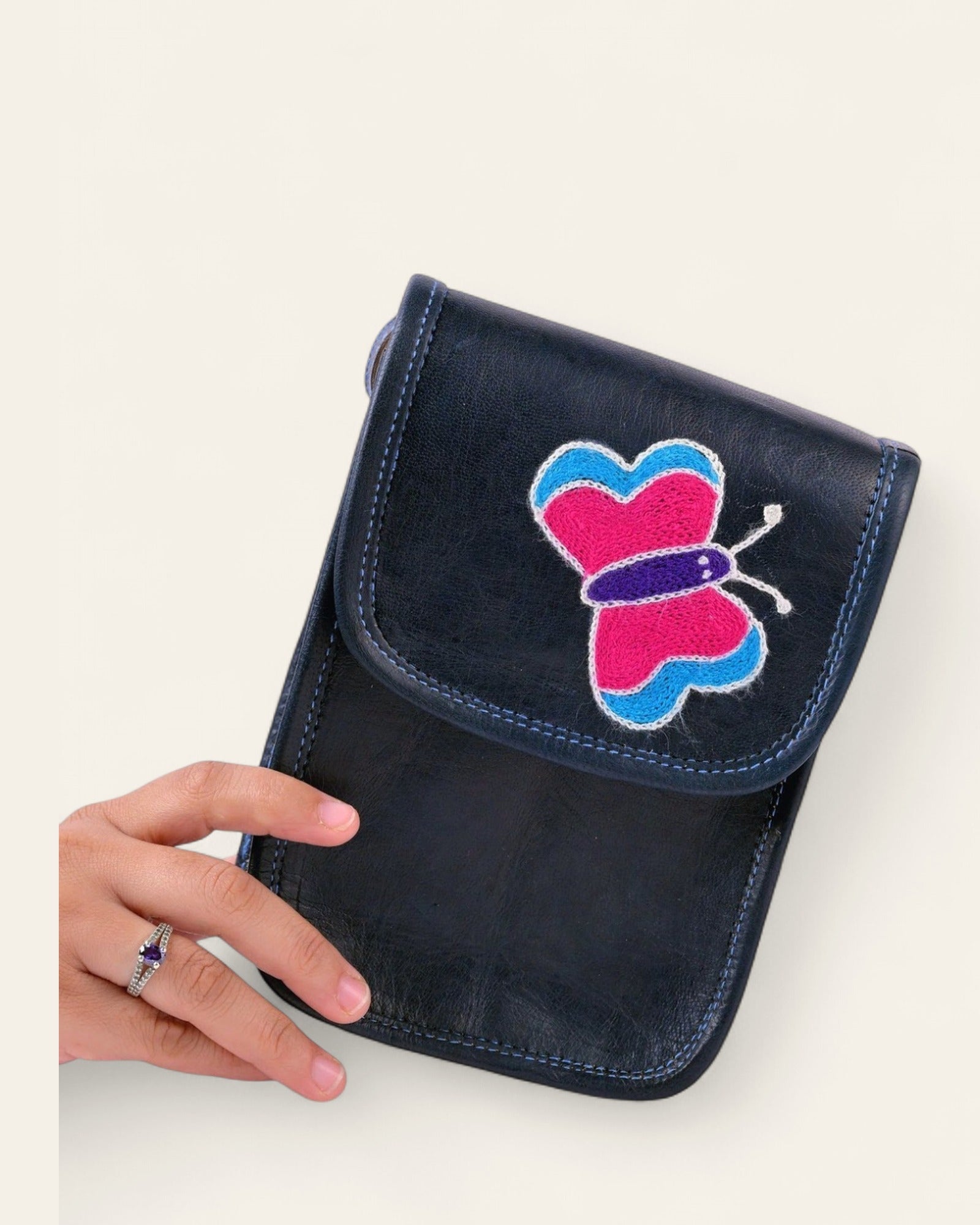 The Nagaur Kashidakari Sling held in hand, showing its compact phone-sling scale