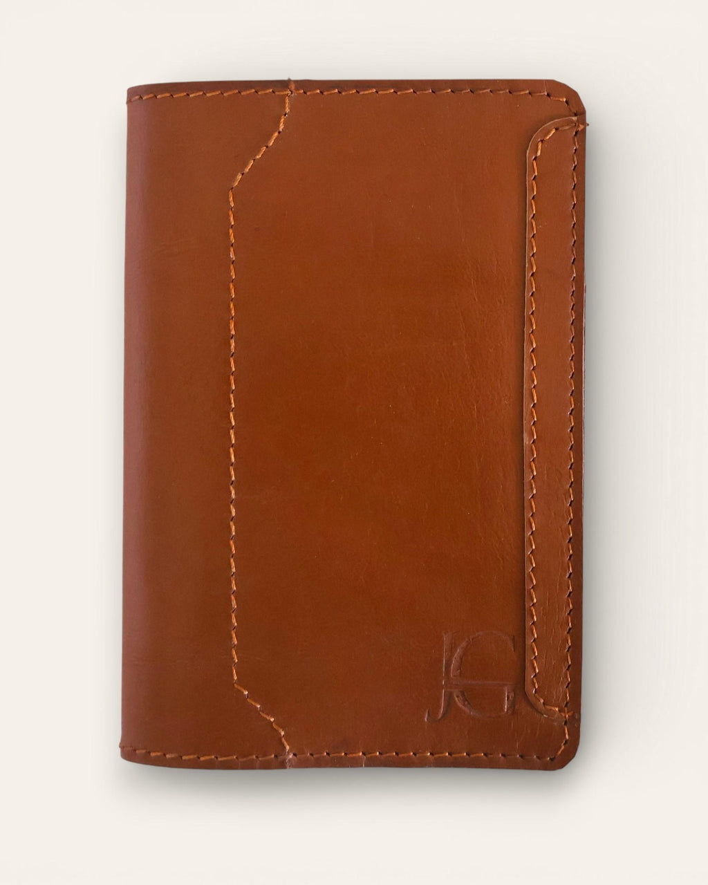 A real leather passport holder in brown color with multiple card slots and a cash slot